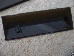 The storage lid removed showing one hinge is missing and the other snapped