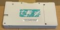 The bottom of the DSi. There is a faded light sea green sticker.